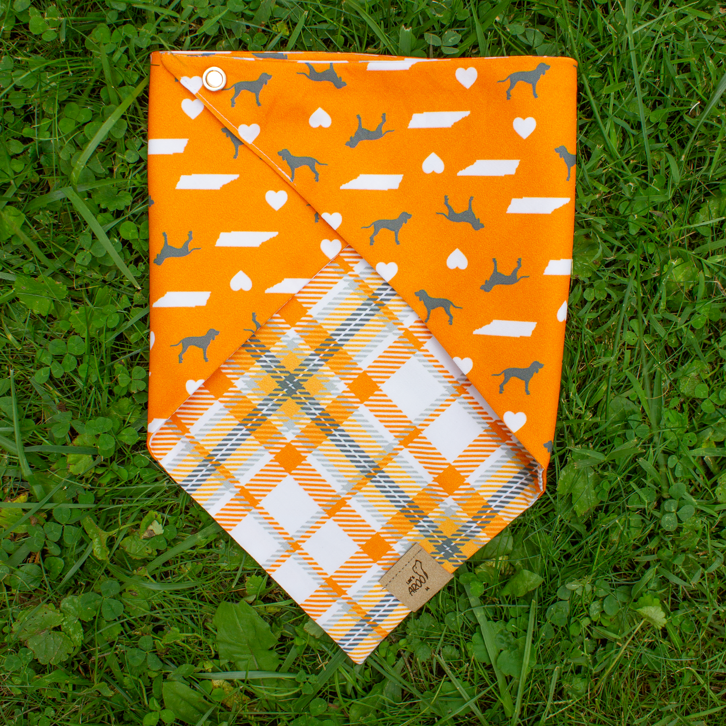Orange dog bandana with pattern on grass