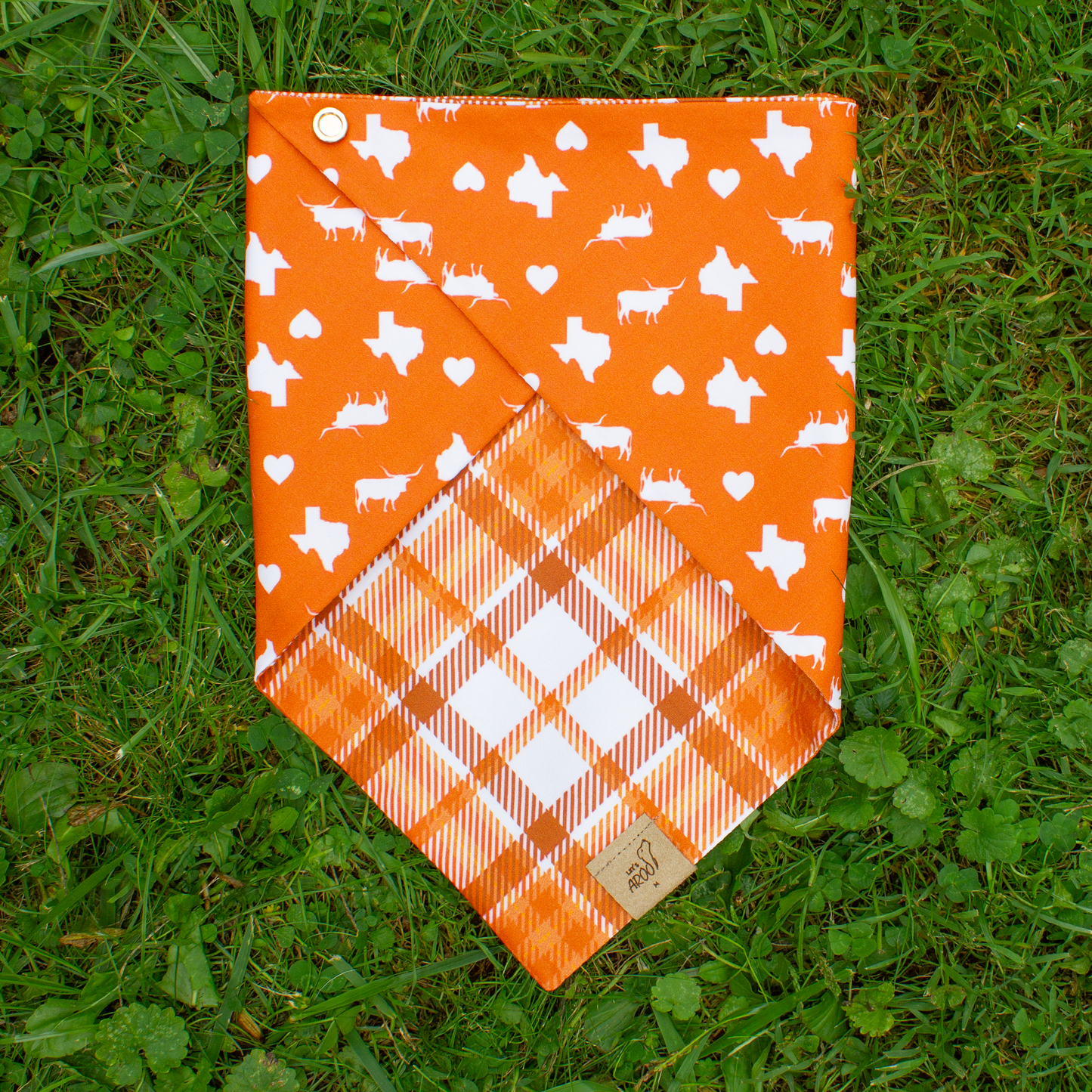 Orange bandana with white patterns on a grassy background